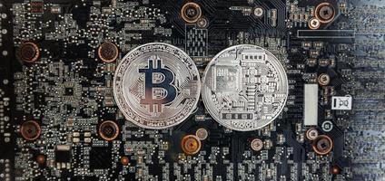 Cryptocurrency silver bitcoin coin lying on video card. Electronic virtual money for web banking and international network payment. Symbol of crypto virtual currency. Mining concept. photo