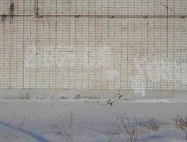 white brick wall and snow. Winter in the city. photo