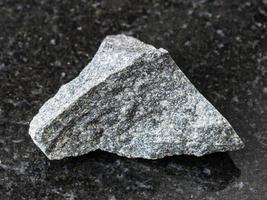 raw olivinite stone on dark background photo