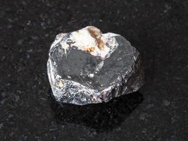 raw Hematite crystal on black photo