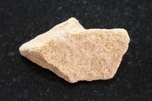 raw sandstone stone on dark background photo