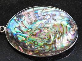 pendant from Abalone haliotis shell on dark photo