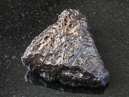 rough Hematite stone on black photo