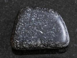 polished Chromite stone on dark background photo