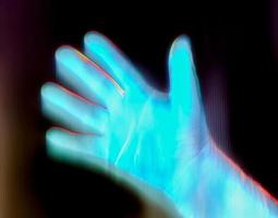 3D-Illustration of a glowing human male hand in an x-ray view. photo