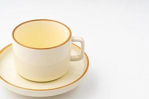 A set of white and brown ceramic plate and cup on a white background photo