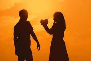 Happy young couple together against beautiful sunset. Freedom, photo