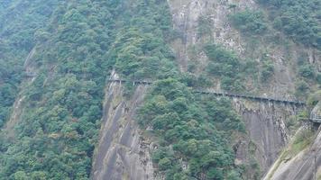 The beautiful mountains landscapes with the green forest and a plank road built along the face of a cliff in the countryside of the China photo