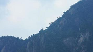 The beautiful mountains landscapes with the green forest and the erupted rock cliff as background in the countryside of the China photo