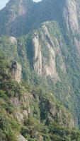 The beautiful mountains landscapes with the green forest and the erupted rock cliff as background in the countryside of the China photo