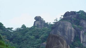 The beautiful mountains landscapes with the green forest and the erupted rock cliff as background in the countryside of the China photo