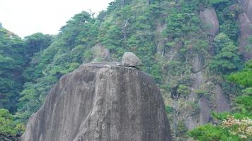 The beautiful mountains landscapes with the green forest and the erupted rock cliff as background in the countryside of the China photo