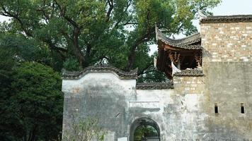 The beautiful traditional Chinese village view with the classical architecture and fresh green trees as background photo