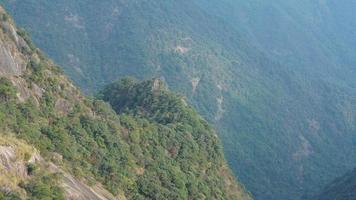 The beautiful mountains landscapes with the green forest and the erupted rock cliff as background in the countryside of the China photo