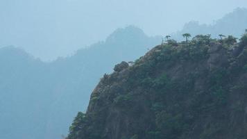 The beautiful mountains landscapes with the green forest and the erupted rock cliff as background in the countryside of the China photo