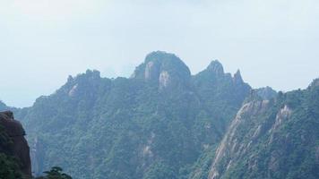 The beautiful mountains landscapes with the green forest and the erupted rock cliff as background in the countryside of the China photo