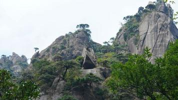 The beautiful mountains landscapes with the green forest and the erupted rock cliff as background in the countryside of the China photo