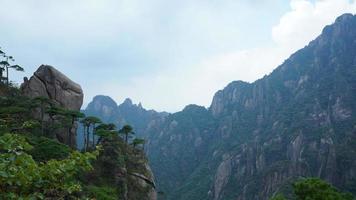 The beautiful mountains landscapes with the green forest and the erupted rock cliff as background in the countryside of the China photo