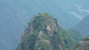 The beautiful mountains landscapes with the green forest and the erupted rock cliff as background in the countryside of the China photo