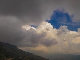 dance of the clouds. cloud and valley view. clouds over green valley photo