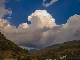 dance of the clouds. cloud and valley view. clouds over green valley photo