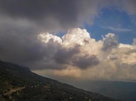 dance of the clouds. cloud and valley view. clouds over green valley photo