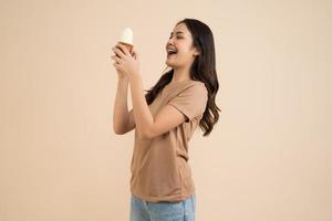 Happy young woman eating ice cream photo