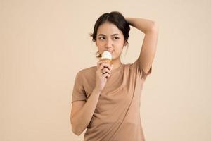Happy young woman eating ice cream photo