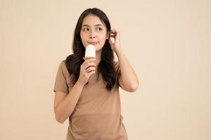 Happy young woman eating ice cream photo