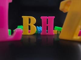 Close up of colorful alphabets on black background perfect for children's education photo