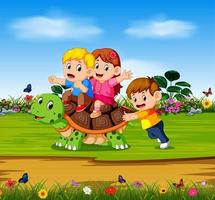 the three children are playing on the big turtle in the forest vector