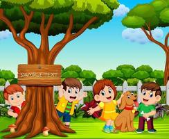 the happy children are playing near the big tree vector