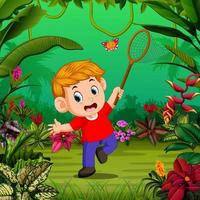 el niño intenta atrapar una mariposa en el jardín vector