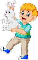 happy boy holding a rabbit vector