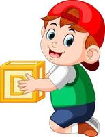 little boy holding the alphabet cube vector