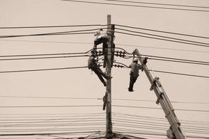 men working on electrical pole photo