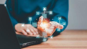 Businessman working at cloud data icon, cloud computing diagram show on hand. Cloud technology. Data storage. Networking and internet service concept. photo