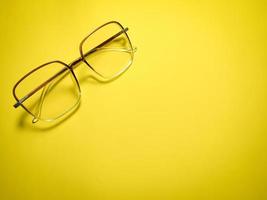 clear glasses on a yellow background  copy space photo