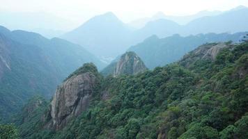 The beautiful mountains landscapes with the green forest and the erupted rock cliff as background in the countryside of the China photo