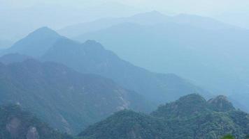 The beautiful mountains landscapes with the green forest and the erupted rock cliff as background in the countryside of the China photo