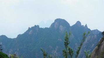 The beautiful mountains landscapes with the green forest and the erupted rock cliff as background in the countryside of the China photo