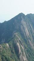 The beautiful mountains landscapes with the green forest and the erupted rock cliff as background in the countryside of the China photo