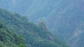 The beautiful mountains landscapes with the green forest and the erupted rock cliff as background in the countryside of the China photo