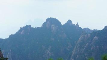 The beautiful mountains landscapes with the green forest and the erupted rock cliff as background in the countryside of the China photo