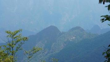 The beautiful mountains landscapes with the green forest and the erupted rock cliff as background in the countryside of the China photo