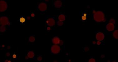 rosso bokeh su particelle galleggiante nel il aria. polvere e luccichio particelle sfondo. nero sfondo , uso mescolanza modalità schermo video