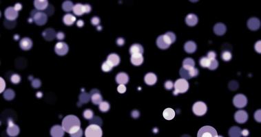 Purple bokeh on particles floating in the air. Dust and glitter particles background. Black background , Use blending mode screen video