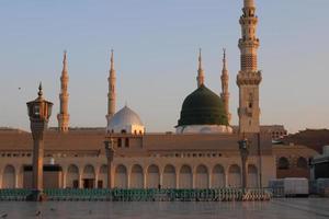 Medina, Saudi Arabia, Oct 2022 - Beautiful daytime view of Masjid Al Nabawi, Medina's green dome, minarets and mosque courtyard. photo