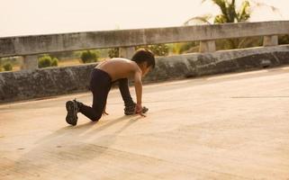 A strong little boy ran along the bridge. photo