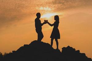 Happy young couple together against beautiful sunset. Freedom, photo